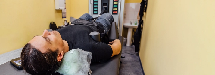 Chiropractic Carrollton TX Intersegmental Traction Therapy A patient laying on a Intersegmental Traction Therapy table.