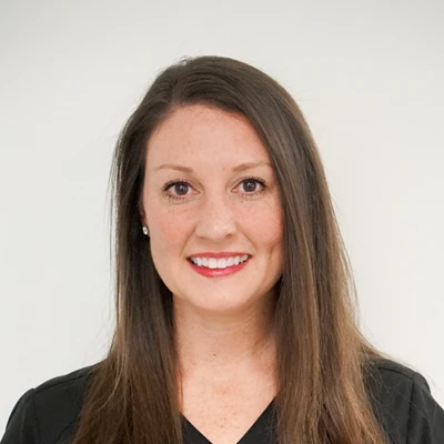 Chiropractor Emilee Quiroz smiling in a black shirt.