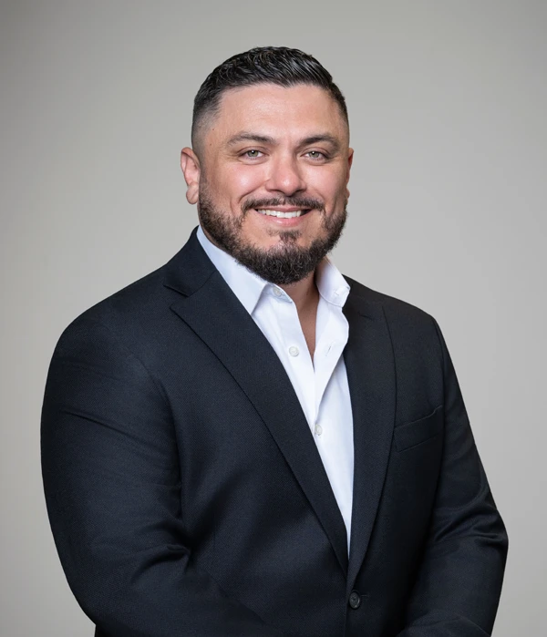 Chiropractor Richardson TX Pierre Quiroz HP Chiropractor Pierre Quiroz smiling while wearing a suit.